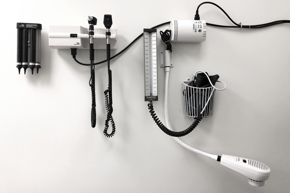 Doctors patient room wall showing exam equipment. 
